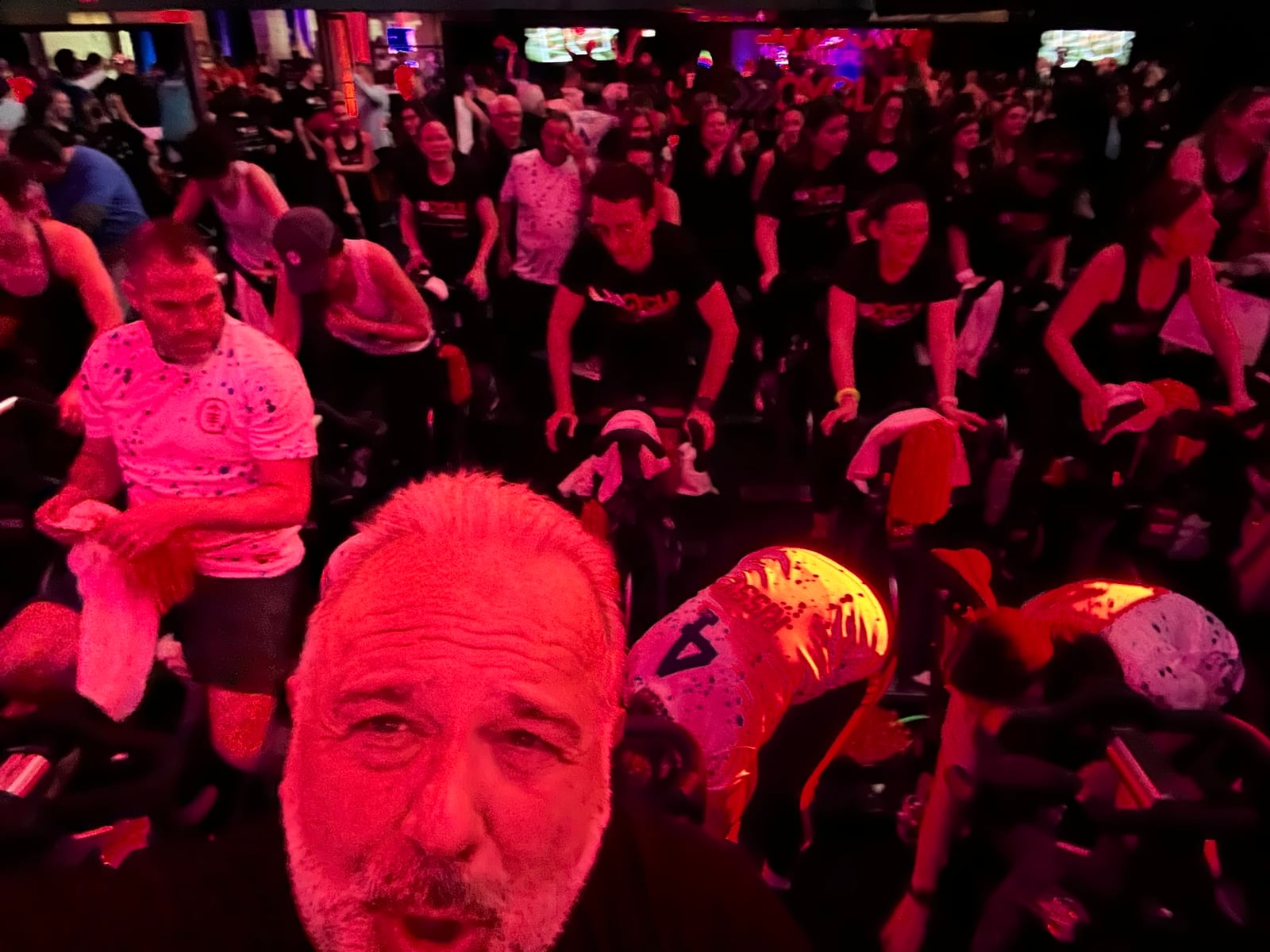Cycle for Survival participants riding stationary bikes at a fundraising event.